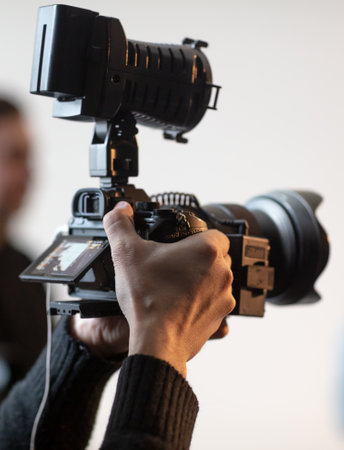 Video camera in the hands of a man. close-upの写真素材