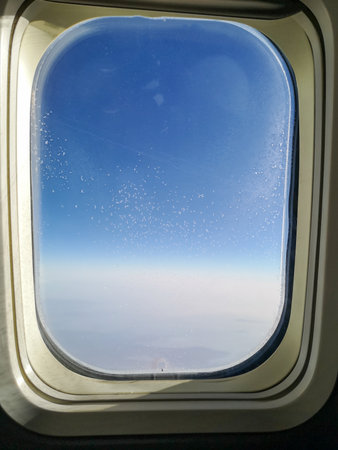 Snowflakes on the glass of an airplane window as a background.