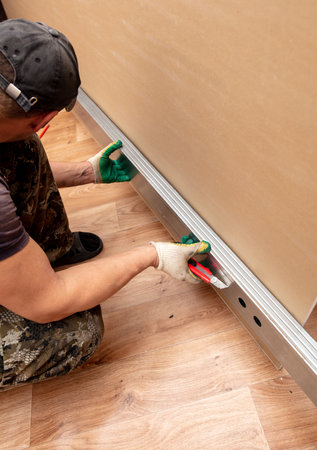 Workers install plasterboard wall in the room.の写真素材