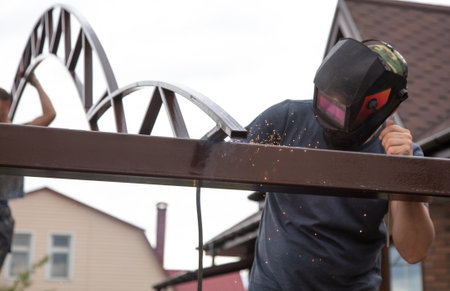 The worker installs the metal on the canopy. constructionの写真素材
