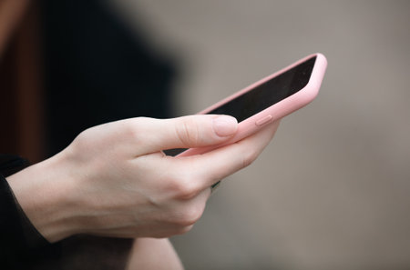 Smartphone in the girl's hand. close-upの写真素材