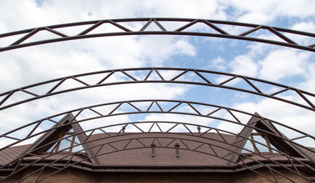 The metal frame of the canopy against the sky. construction