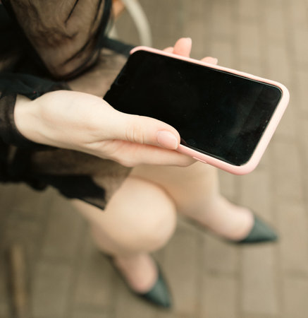 Smartphone in the girl's hand. close-upの写真素材