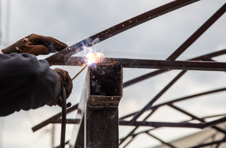 A worker welds metal at a construction site. Technologies