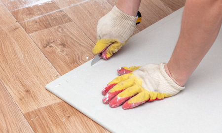 A worker cuts drywall. Repair in the roomの写真素材