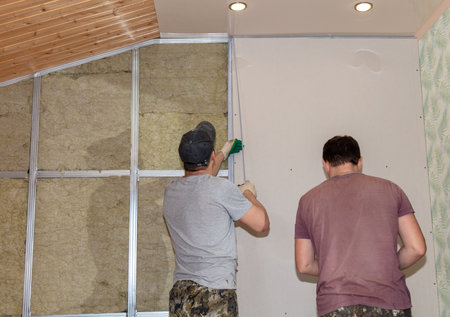 Workers install a plasterboard wall.の写真素材