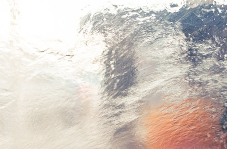 Wet glass on a car in a car wash. background.の写真素材