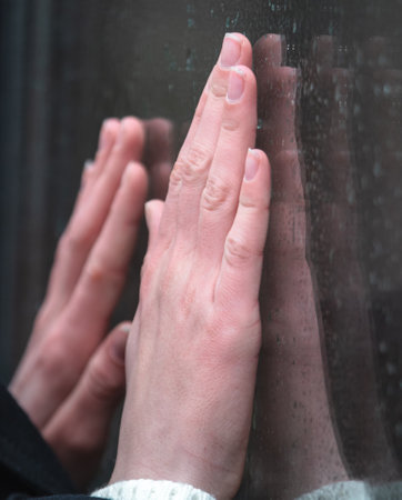 Girl's hand with glass reflection. close-upの写真素材