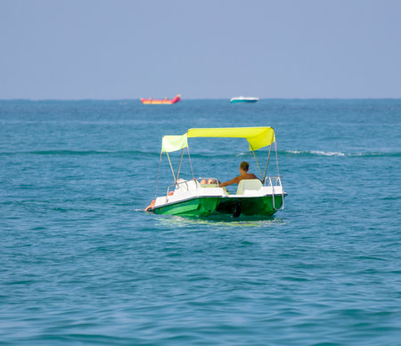 The yacht floats on the waves of the sea.の写真素材