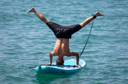 A man on a board floats on the waves of the sea.