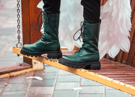 Women's boots on a park bench.