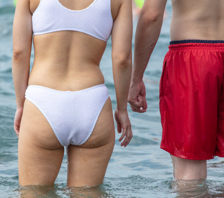 A man and a woman in a bathing suit swim in the sea.の写真素材