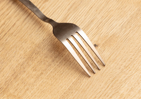 Fork on the wooden table, closeup shot, shallow depth of field.の写真素材