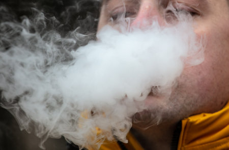 Smoke from the mouth of a smoking man.
