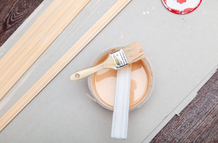 Paint brush and paint can on a wooden table.の写真素材