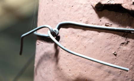 close-up of an old iron wire on a pipe in the garden.の写真素材