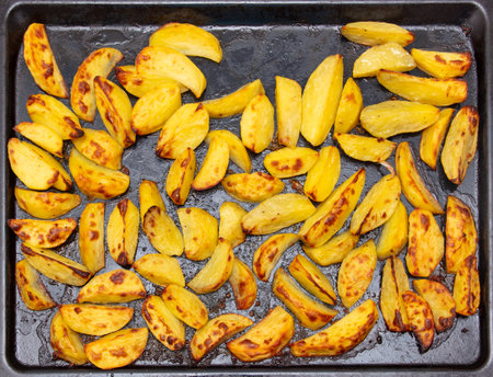 Potatoes baked in the oven as a background. close-upの写真素材