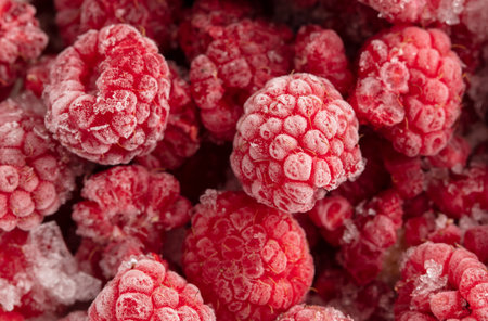 Frozen raspberries and blackberries close-up macro photography.