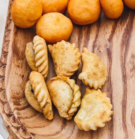 Fried donuts on a wooden tray.の写真素材