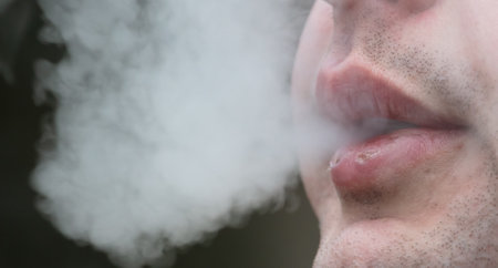 Smoke from the mouth of a smoking man.
