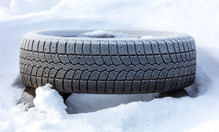 Car wheel on snow in winter. close-upの写真素材