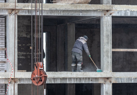 The worker sweeps the garbage at the construction site of the house.の写真素材