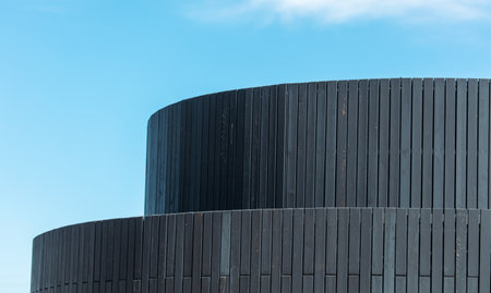Detail of the exterior of a modern building with a blue sky.の写真素材
