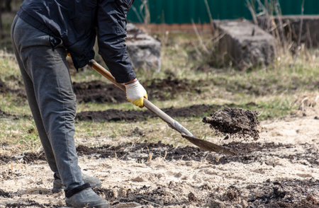 A man digs the soil with a shovel. selective focus. nature.