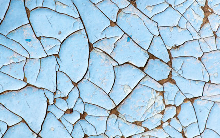 Cracked blue paint on the surface of the old wall as a background.の写真素材