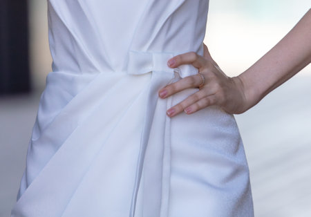 Wedding dress on the bride's hand, close-upの写真素材