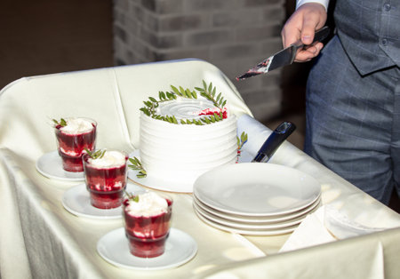 Cherry dessert with whipped cream and mint in small glasses on the table.