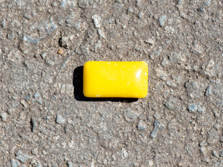 Yellow chewing gum lies on the pavement.の写真素材