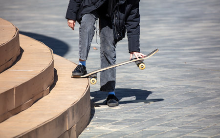 A boy does a trick on a skateboard from the steps.