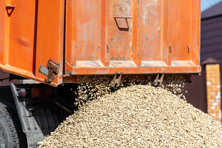 Truck pours rubble on the groundの写真素材