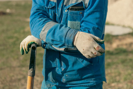 Close-up of a man's hands wearing construction gloves.の写真素材