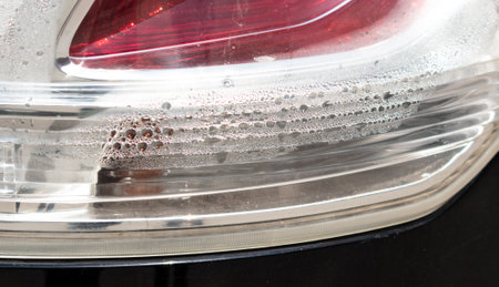 Drops of water in the headlight of a car. close-up.の写真素材