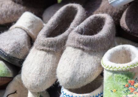 Handmade woolen slippers on sale at a flea market.