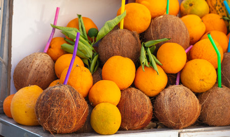 Oranges with coconuts on the counter in the market.の写真素材