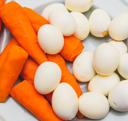 Boiled eggs and carrots as a background. foodの写真素材