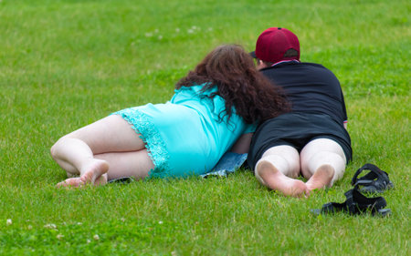 Man woman lie on grass lawn.の写真素材