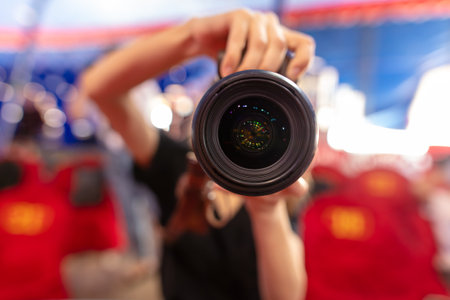 The camera is in the hands of a female photographer. Close-upの写真素材