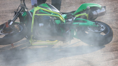 Smoke from under the wheel of a motorcycle.