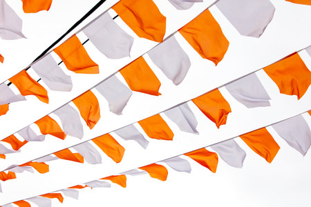 Orange and white festive flags isolated on white background.の写真素材