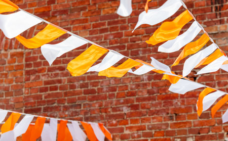 Festive white-orange flags as a background.の写真素材