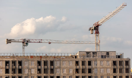 Tower crane at the construction site of a multi-story building.