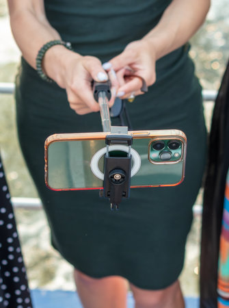 The takes smartphone photos using a selfie stick. Close-up.の写真素材