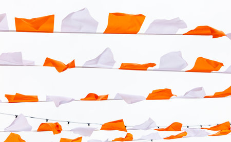 Orange and white festive flags isolated on white background.の写真素材