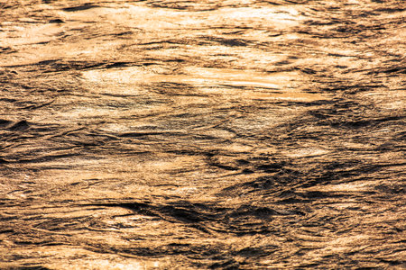 The surface of the water in the river at sunset.の写真素材