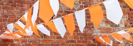 Festive white-orange flags as a background.の写真素材