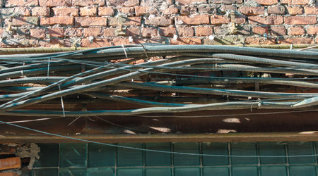 Old cables on the wall of the house.